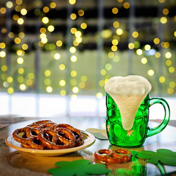 Plate of pretzels and beer mug on table
