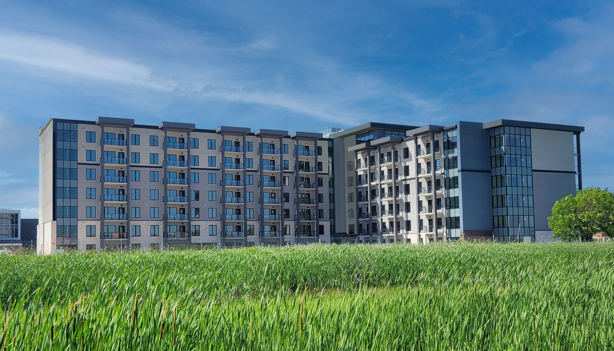 Exterior of Concordia Village 5 building with blue skies and green grass